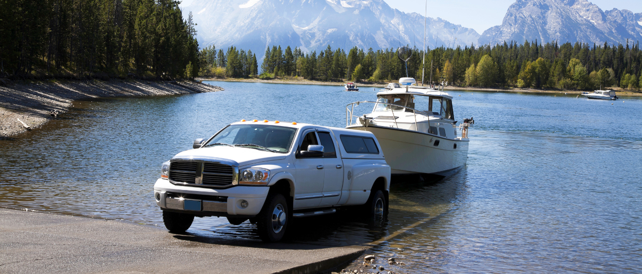 CURT trailer hitches - Dodge Ram truck launching boat into lake CURT trailer hitches - Dodge Ram truck launching boat into lake
