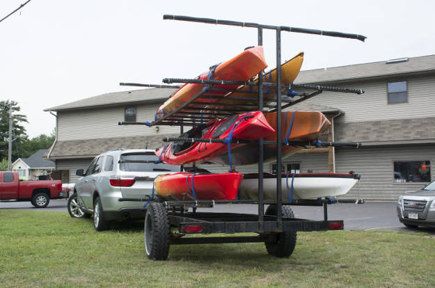 SUV Towing Kayak Trailer in Parking Lot