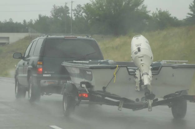 Truck Towing Boat Trailer in Rain