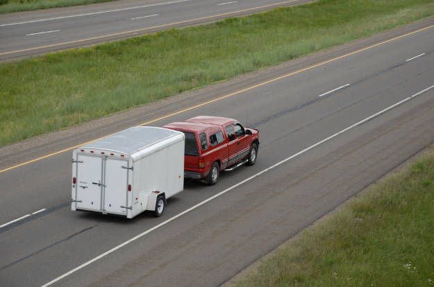 Truck Towing Utility Trailer on Highway