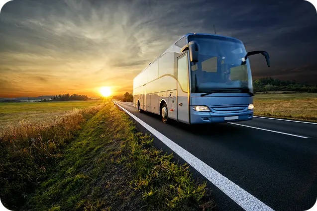 Luxury bus driving at sunset