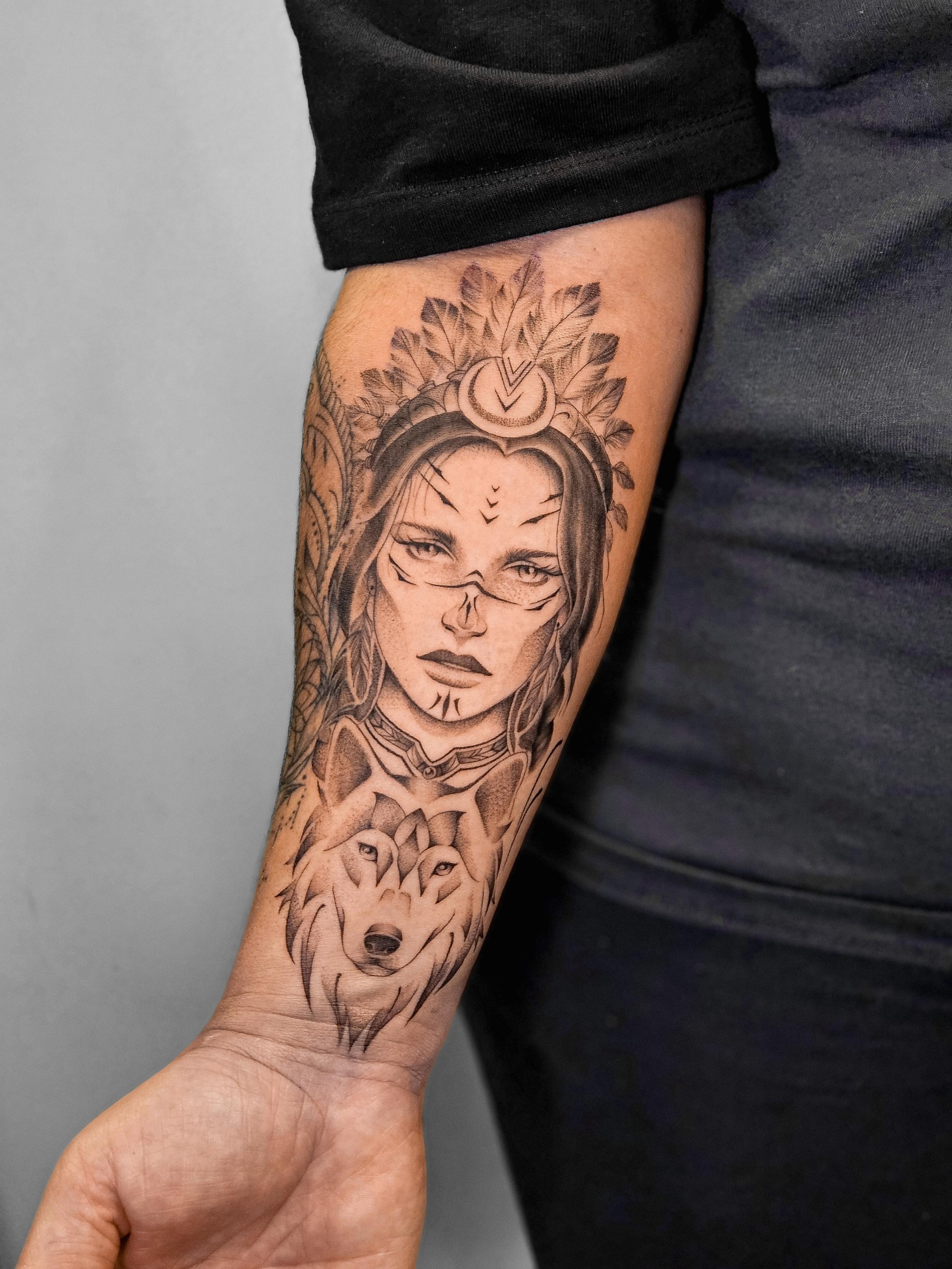 Ce tatouage réaliste complexe s'étend sur l'avant-bras et présente une composition verticale élaborée. L'élément central est…