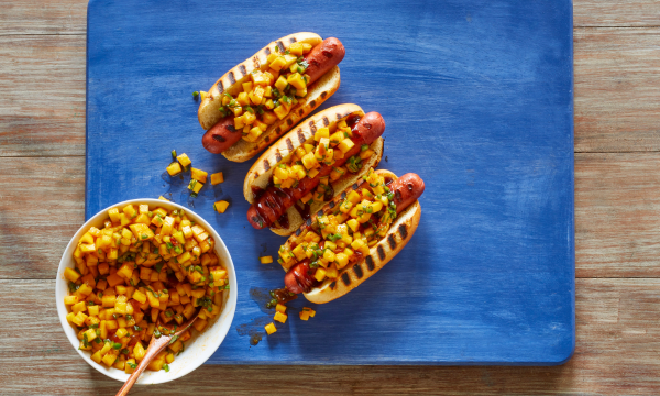 Hot dogs topped with mango, pineapple, chipotle chili pepper and jalapeños.