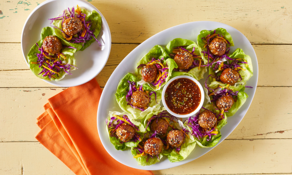 Plate with meatballs, lettuce, and sauce