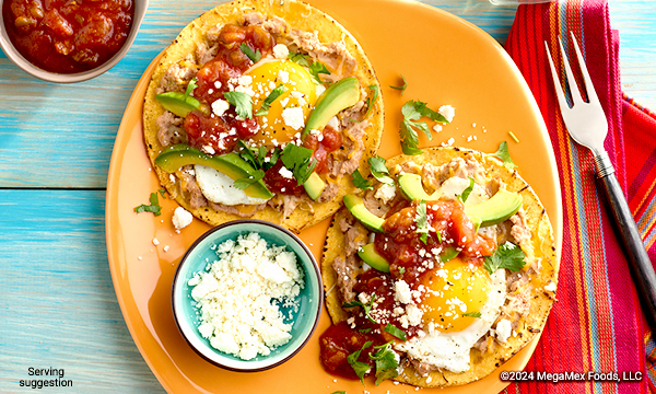 Tostadas topped with egg, cheese, salsa, and avocado 