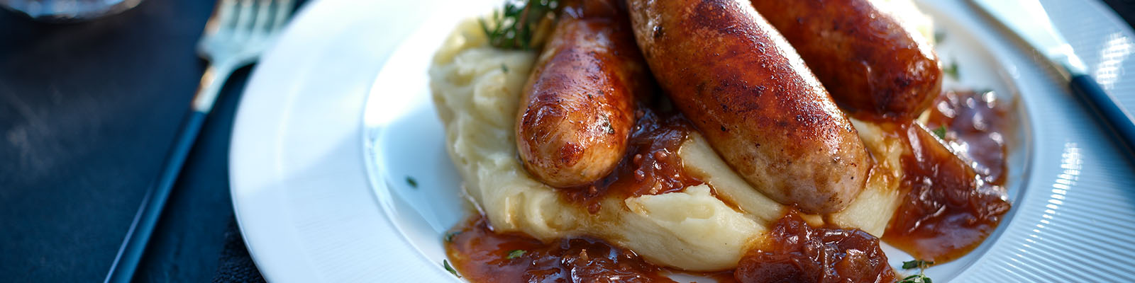 Neven Maguire's Bangers & Cheesy Mash with Caramelised Red Onion Gravy