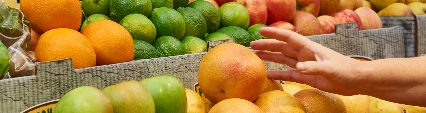 hand reaching for an orange