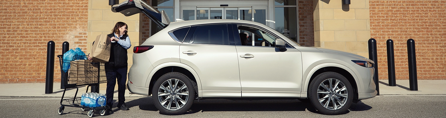 Heinen's Associate loading a curbside pickup order into a car