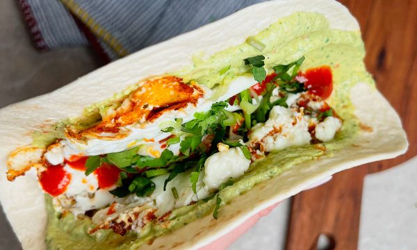 Tortilla with advacado, feta cheese and egg, with siracha sauce