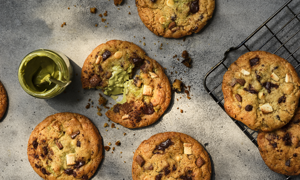 Chocolate chip cookies with chunks of white and dark chocolate, filled with pistachio spread
