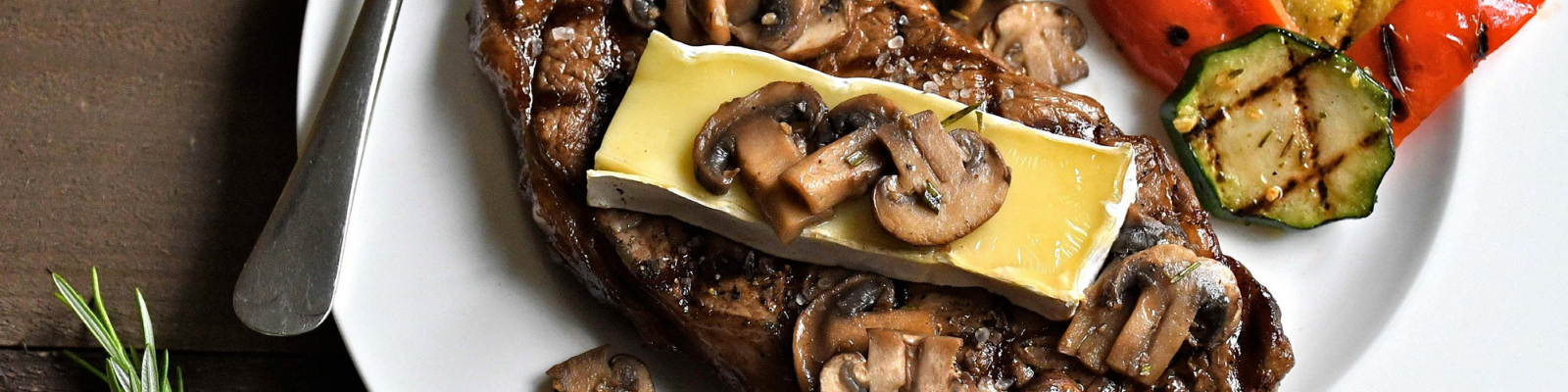 Strip Loin Steaks with Brie and Rosemary-scented Mushrooms