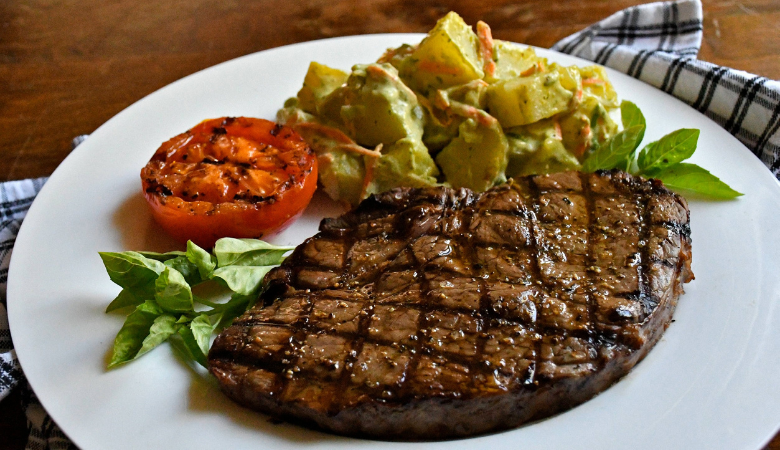 Grilled Sirloin Steaks with Charred Tomatoes and Pesto Potato Salad