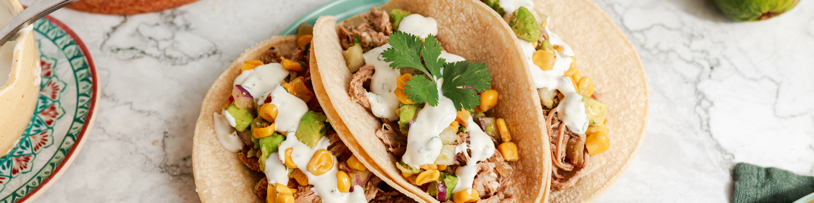 Slow Cooker Pork Carnitas with Corn Salsa and Lime Crema