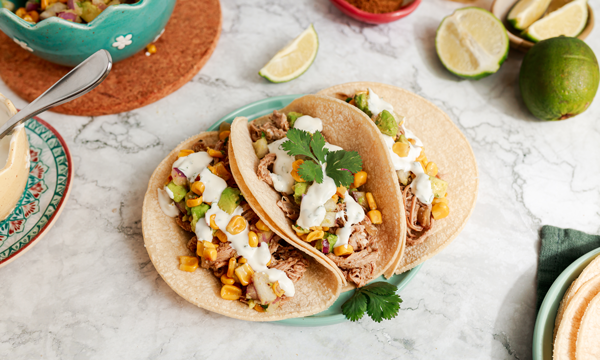 Slow Cooker Pork Carnitas with Corn Salsa and Lime Crema