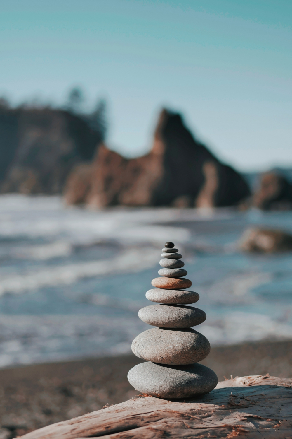 Stones stacked on top of each other near a beach