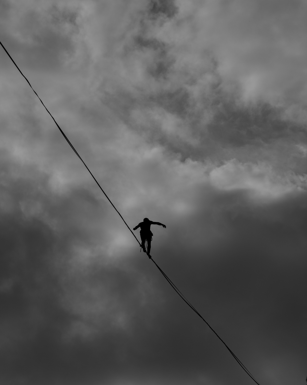 man on a tightrope against a sky background