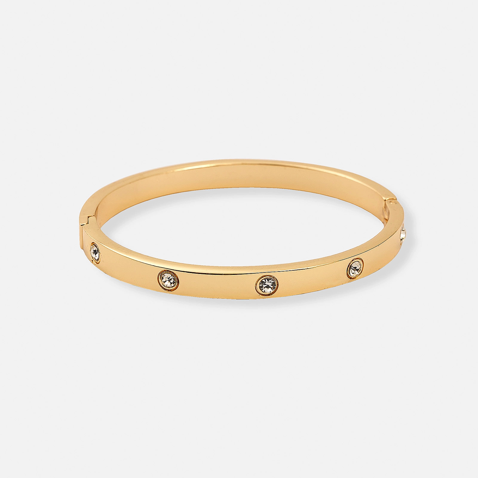Elegant guldfärgad bangle med vita stenar