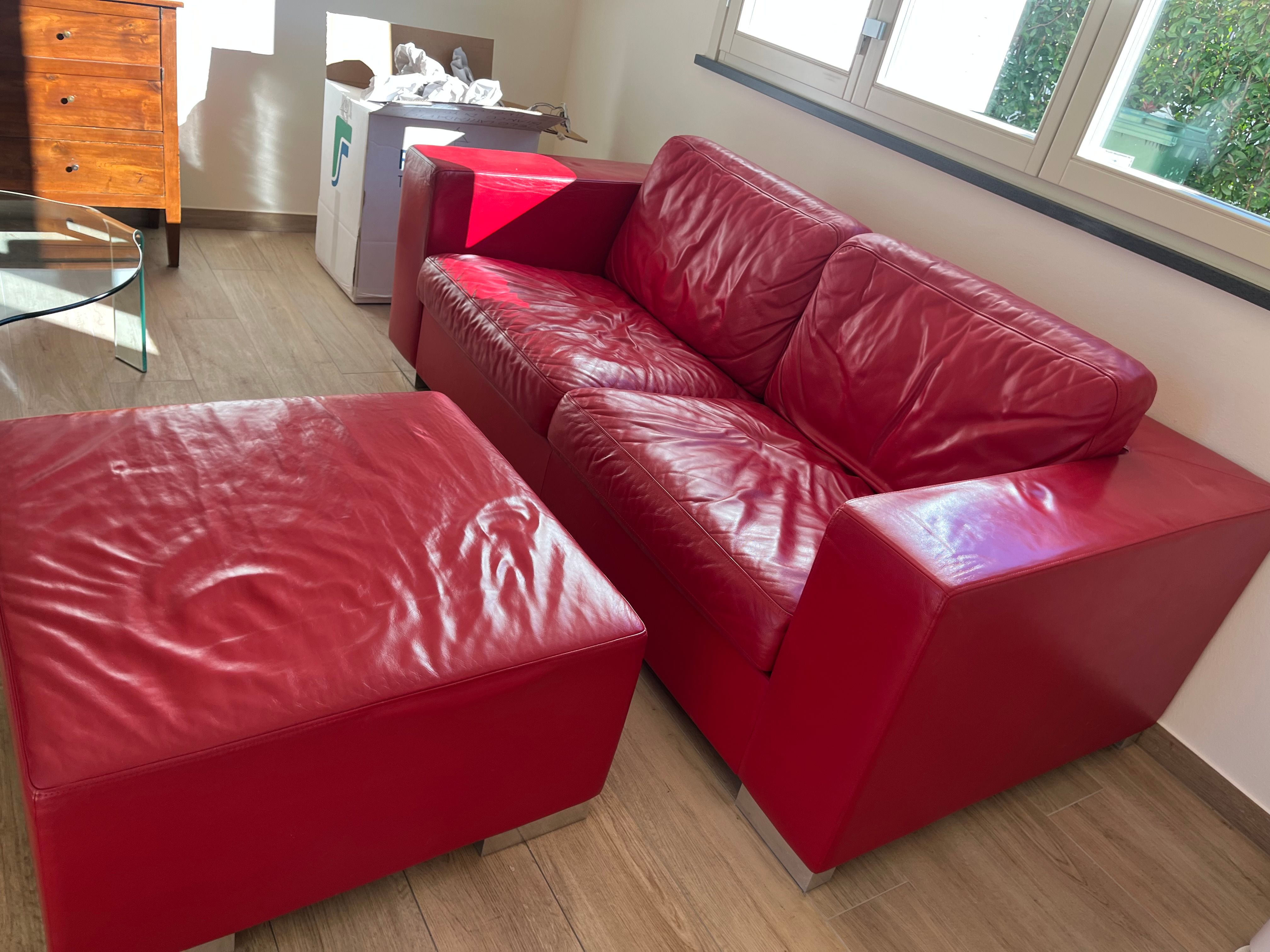 Set of 2 seater sofa and Massimo pouf upholstered in red leather, Poltrona Frau Main
