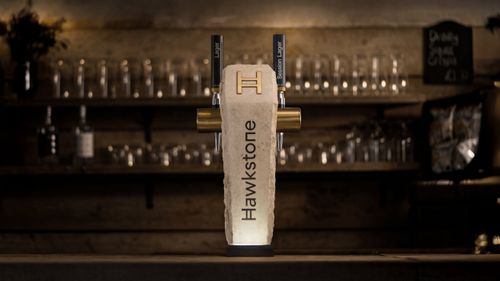 Image of Hawkstone beer fount made out of Cotswold limestone on a bar