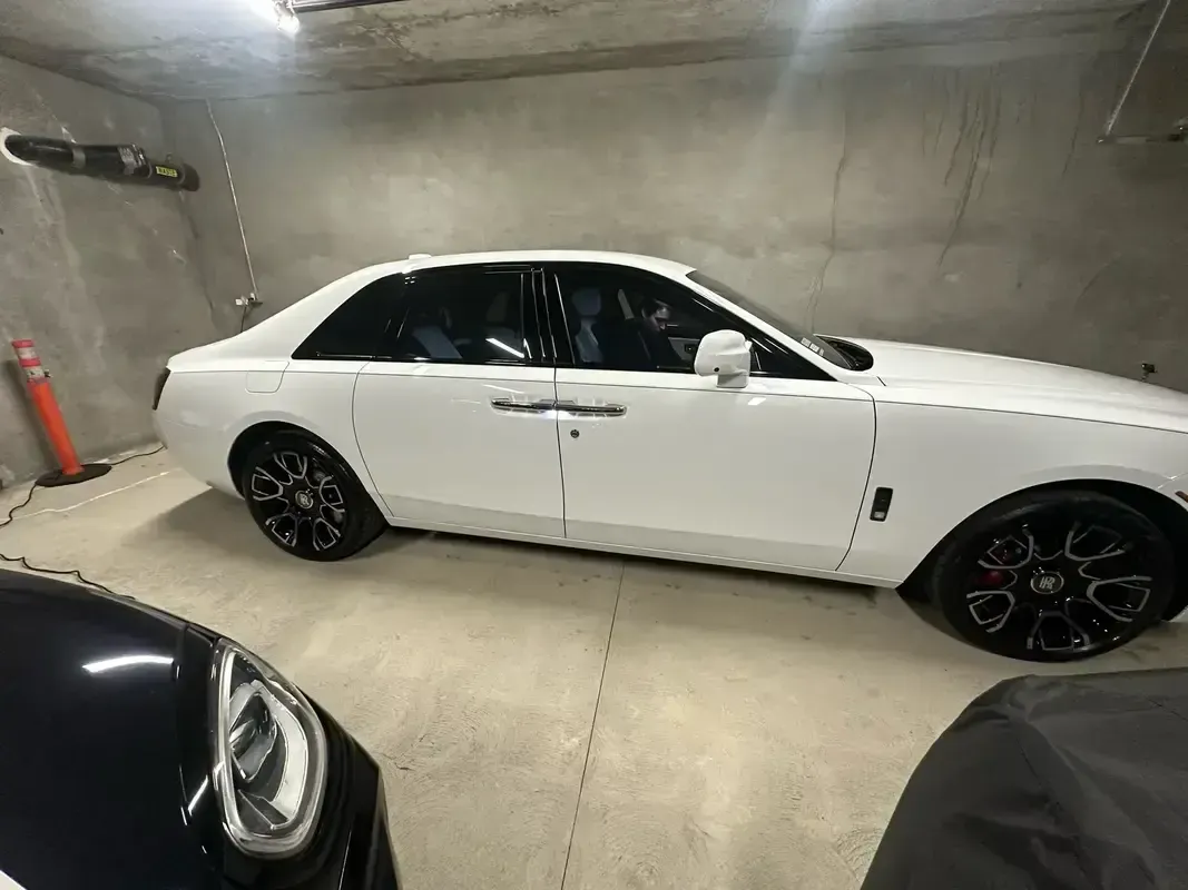 White Rolls-Royce Ghost side profile showing mirror-like paint and detailed black wheels