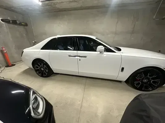 White Rolls-Royce Ghost side profile showing mirror-like paint and detailed black wheels
