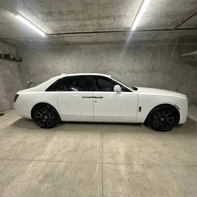 White Rolls-Royce Ghost side profile showing mirror-like paint and detailed black wheels