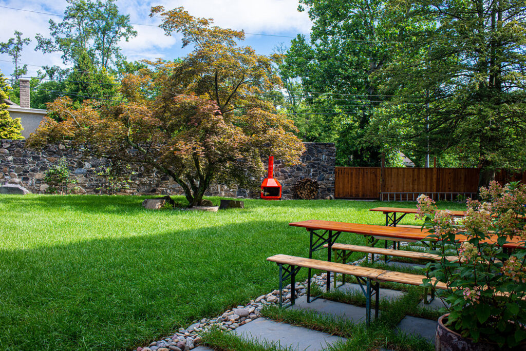 Courtyard and red stove next to picnic tables