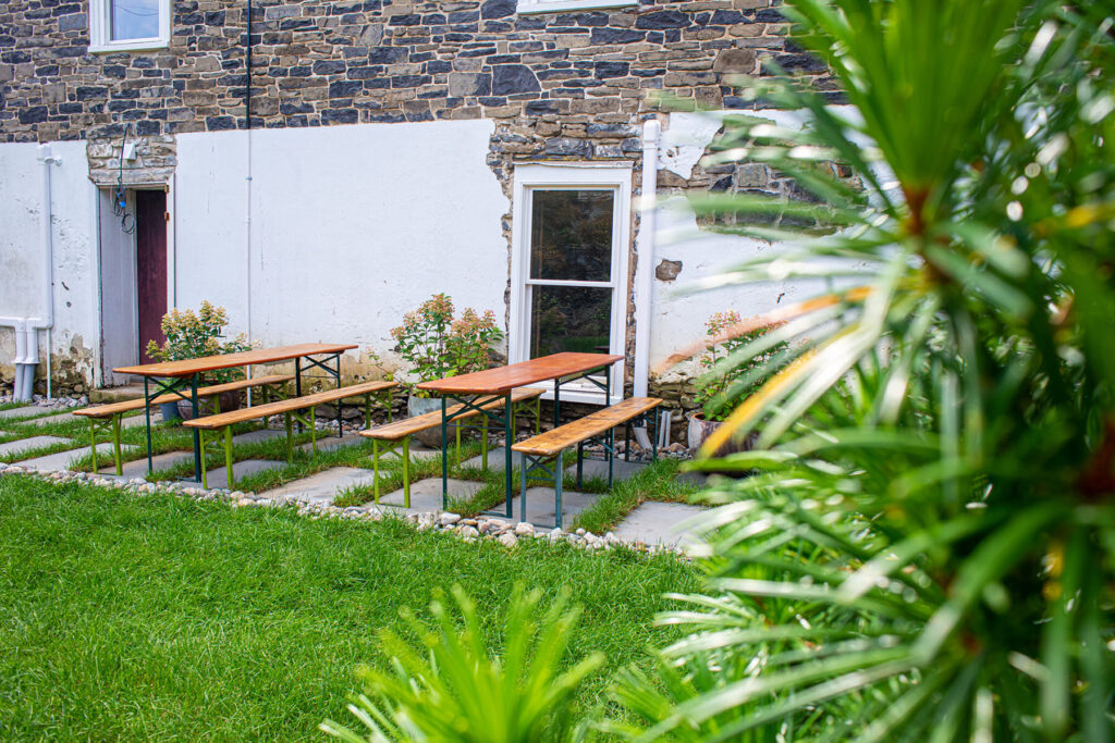 Picnic tables against the Dharma Bums building