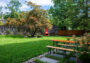 Courtyard and red stove next to picnic tables