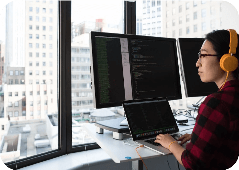 A developer coding on a laptop