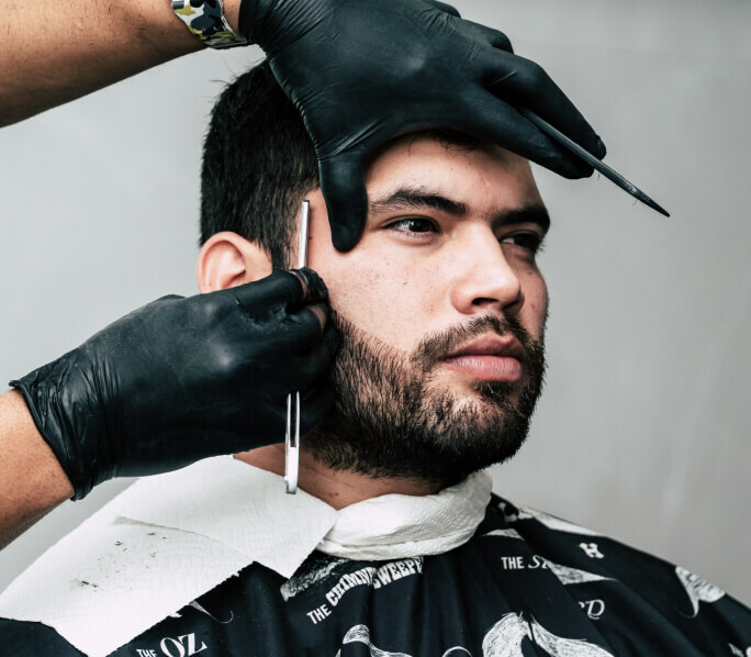 A man getting his beard shaved