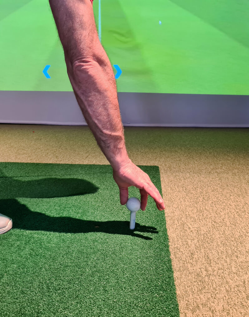 A person holding a golf ball