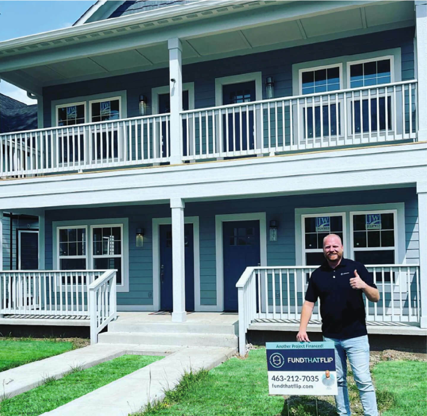 A person in front of a big house