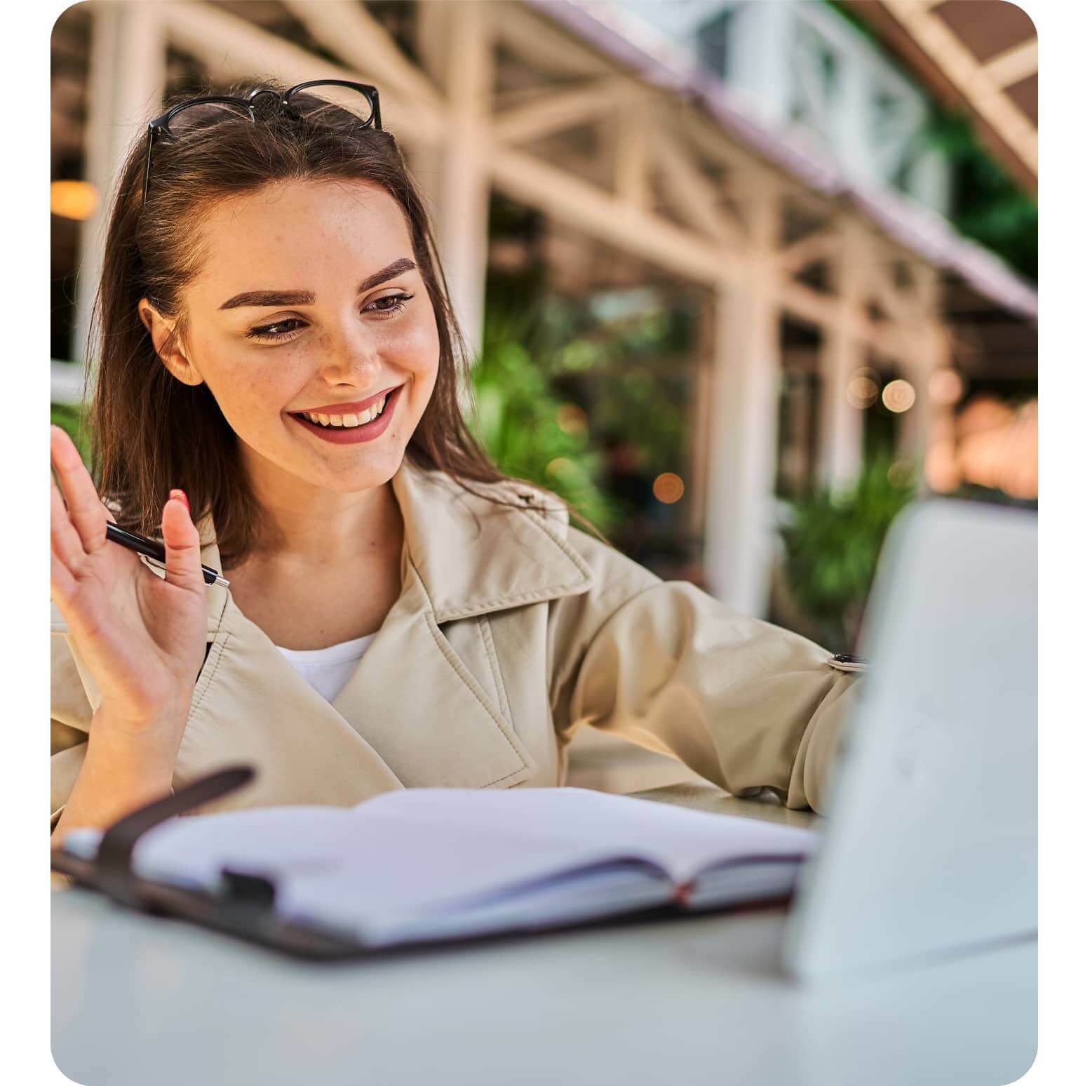 A person waving in front of a computer