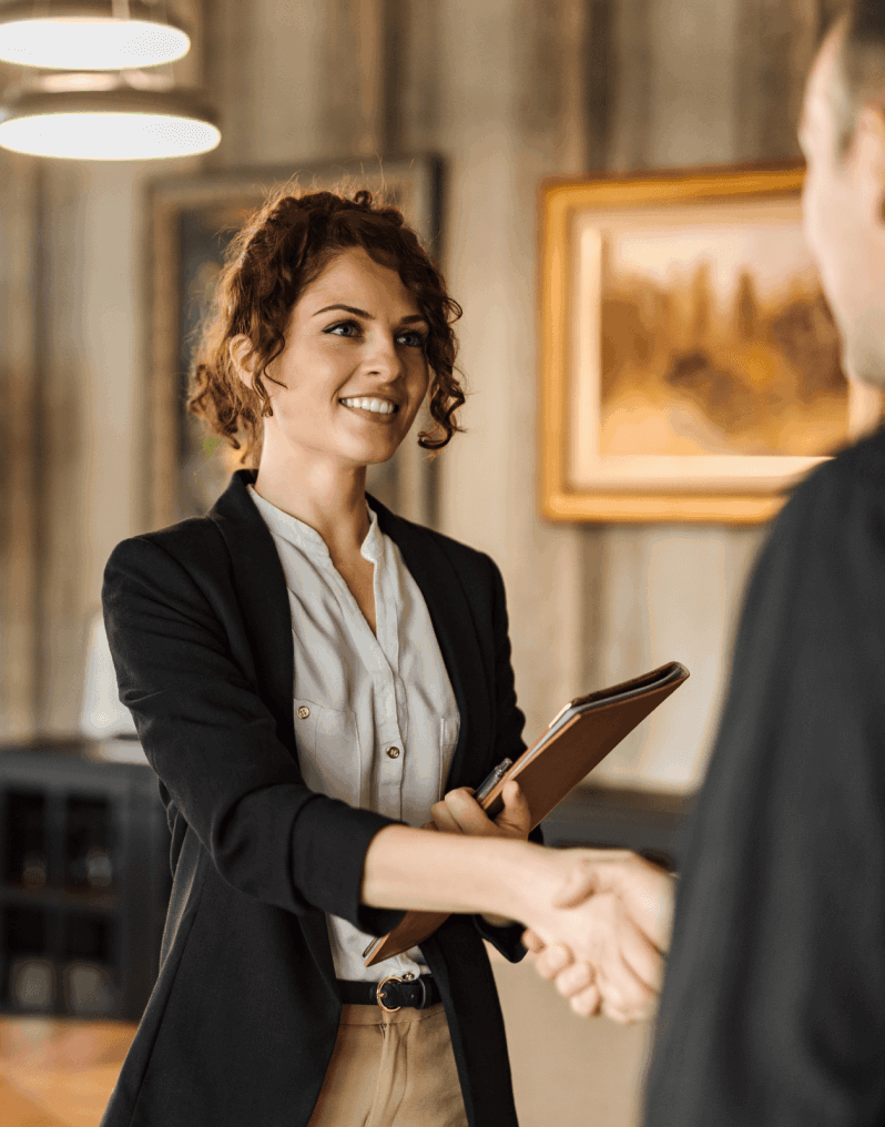 A woman shaking hands with a man