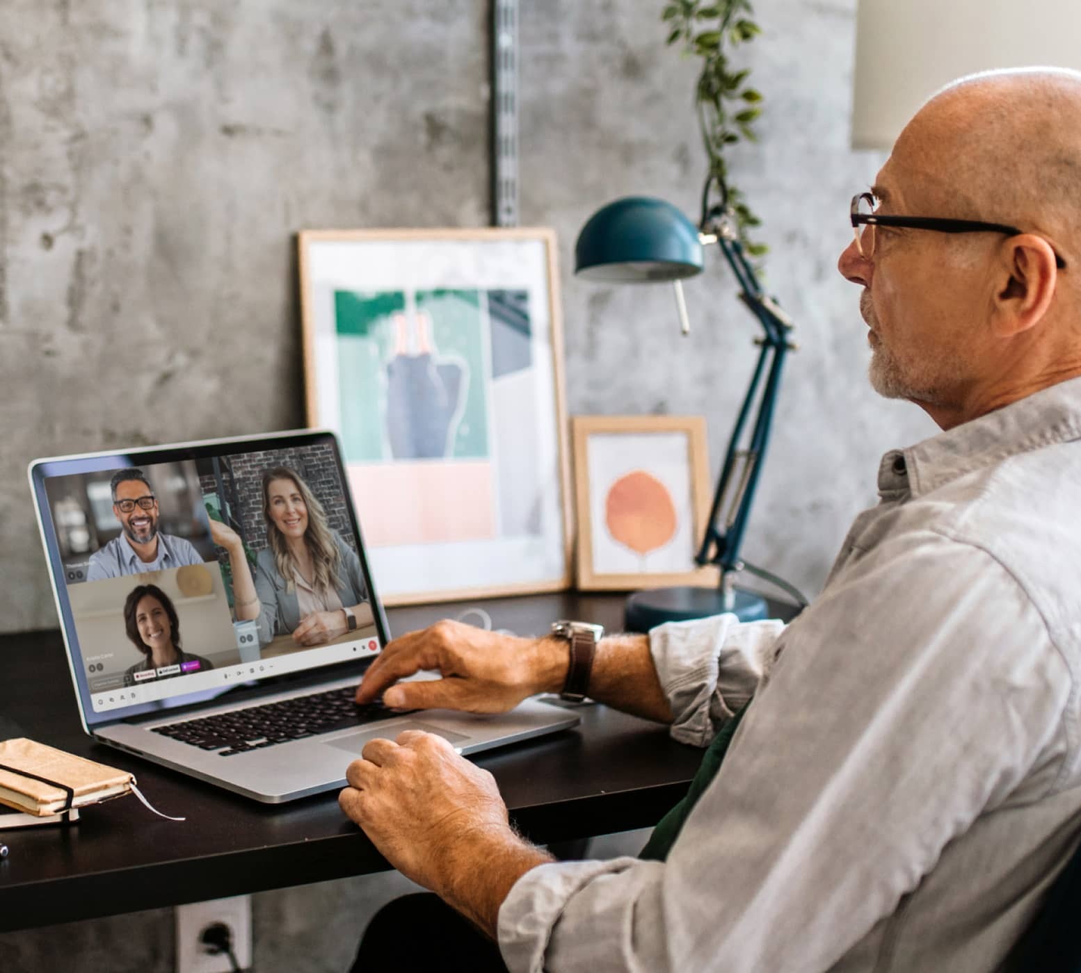 A person attending a video conference on his laptop