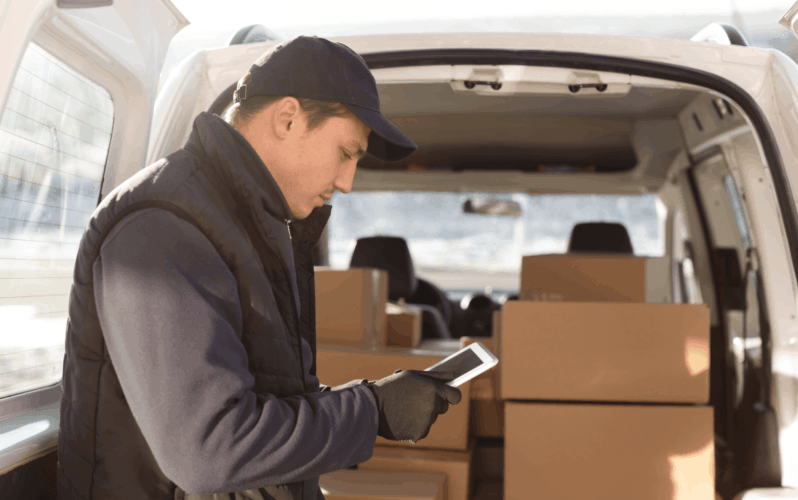 A delivery guy holding a tablet