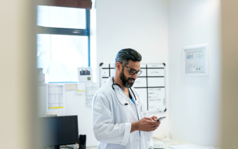 Photo of a physician using a mobile phone