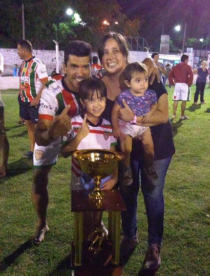 El gran goleador, junto a su familia, con la copa de campeón.