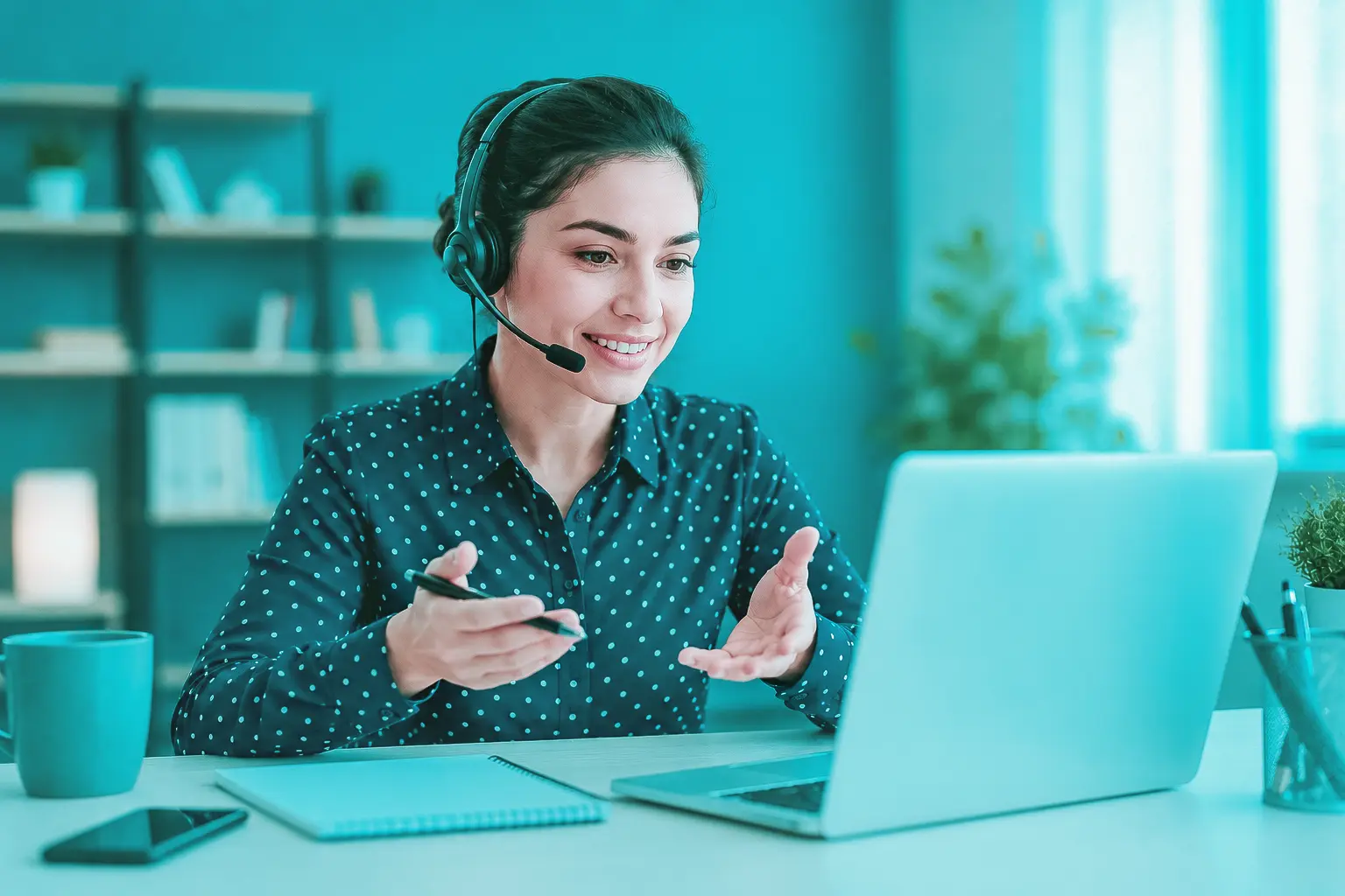 Profissional com headset realiza atendimento consultivo ao cliente pelo notebook.