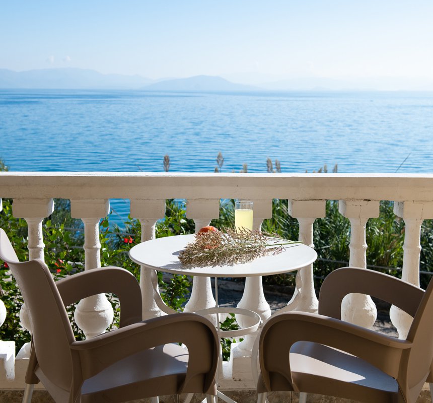 Dimitra Studios, balcony with a table and sea view