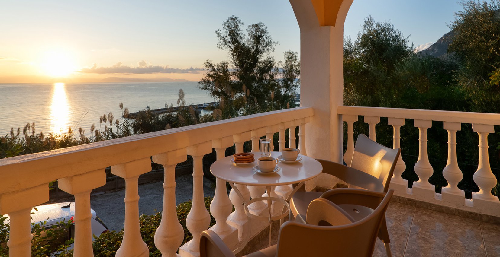 Dimitra Studios, balcony with a table and sea view