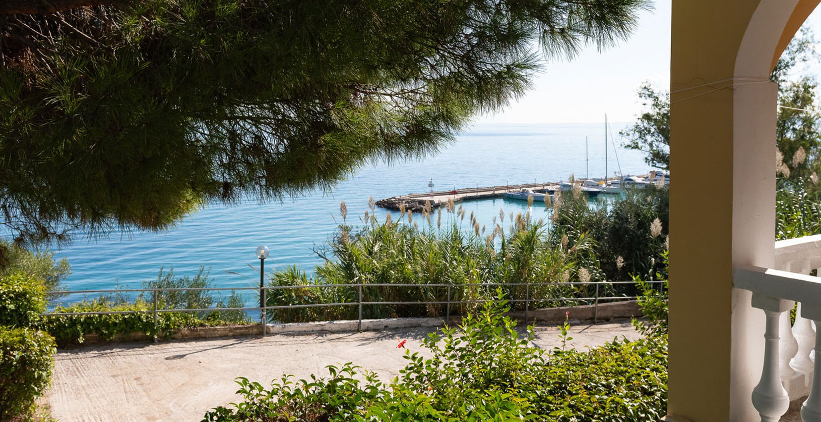 Dimitra Studios, balcony with a table and sea view