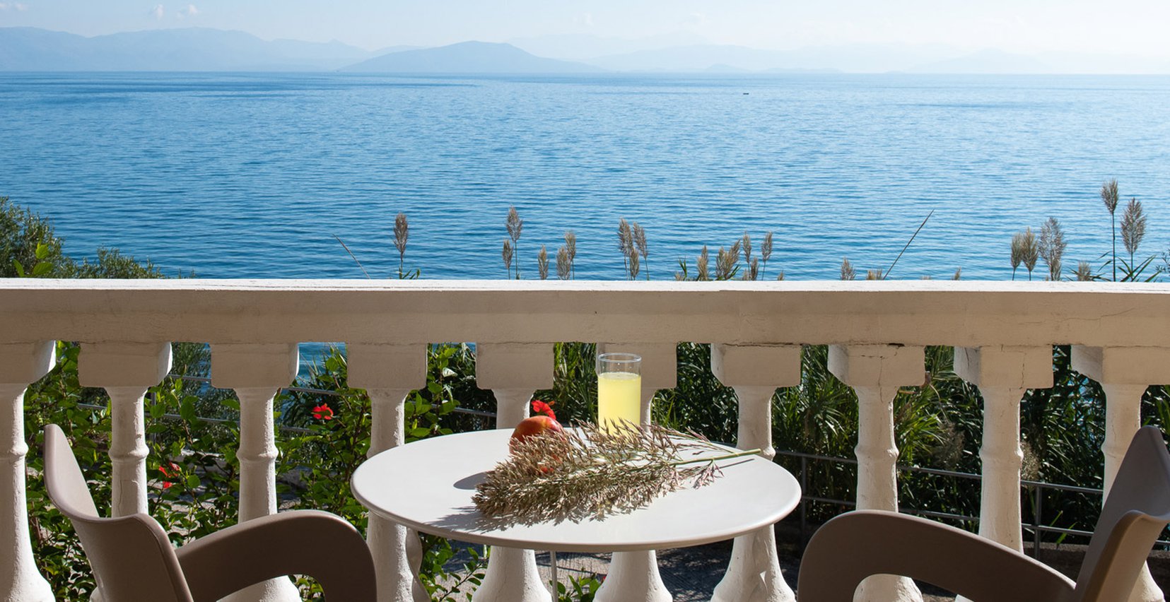 Dimitra Studios, balcony with a table and sea view