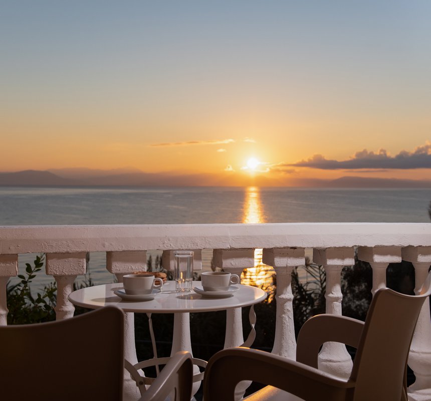 Dimitra Studios, balcony with a table and sea view