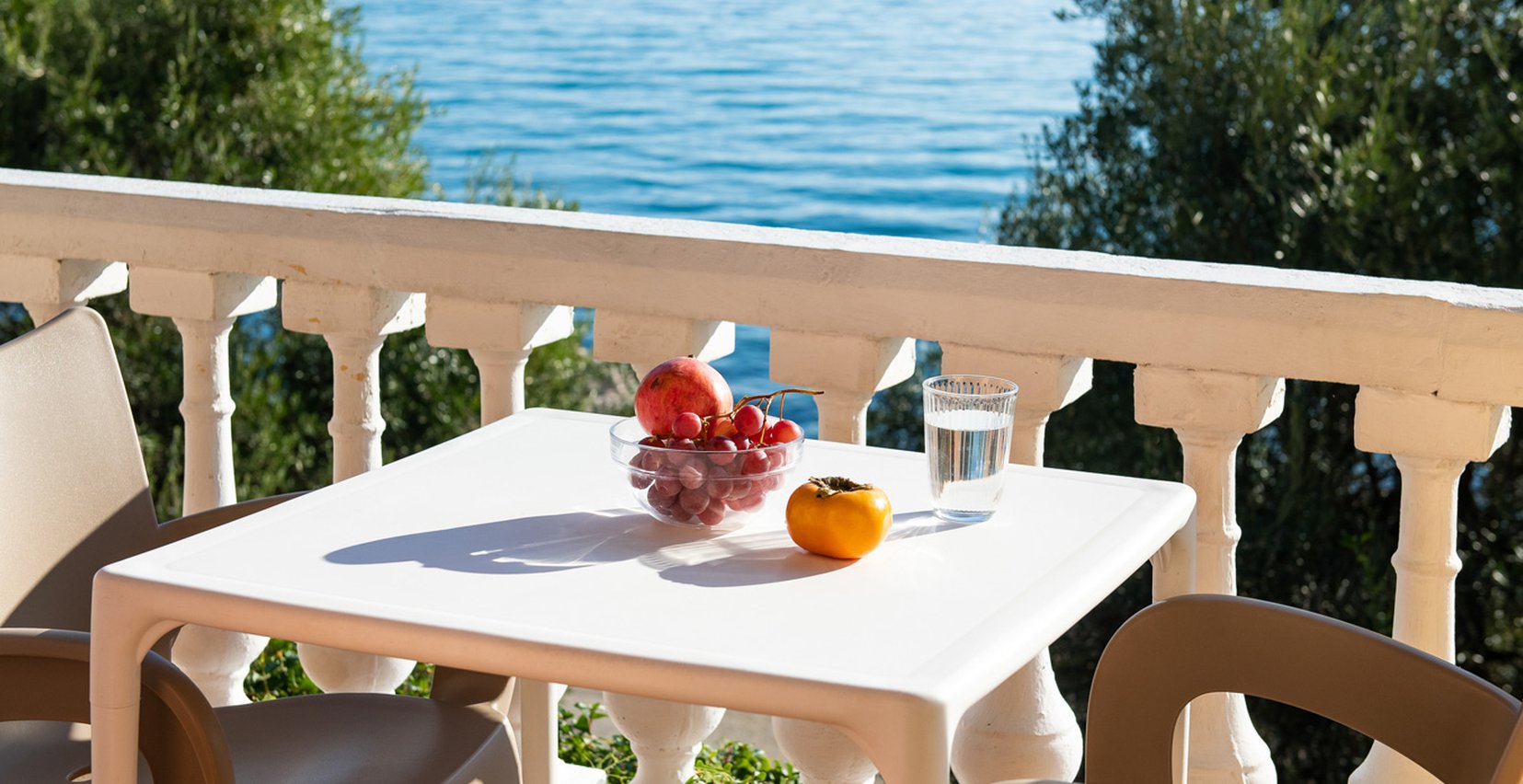 Dimitra Studios, balcony with a table and sea view