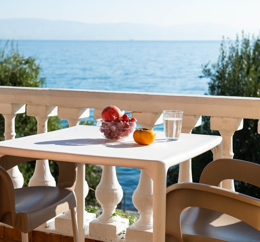 Dimitra Studios, balcony with a table and sea view