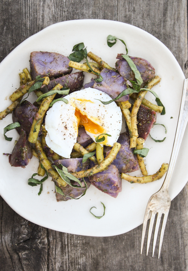 blue potato salad with yellow wax beans poached egg and basil dressing