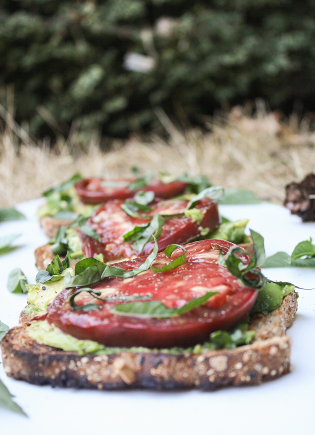 garlic avocado toast with heirloom tomato and basil