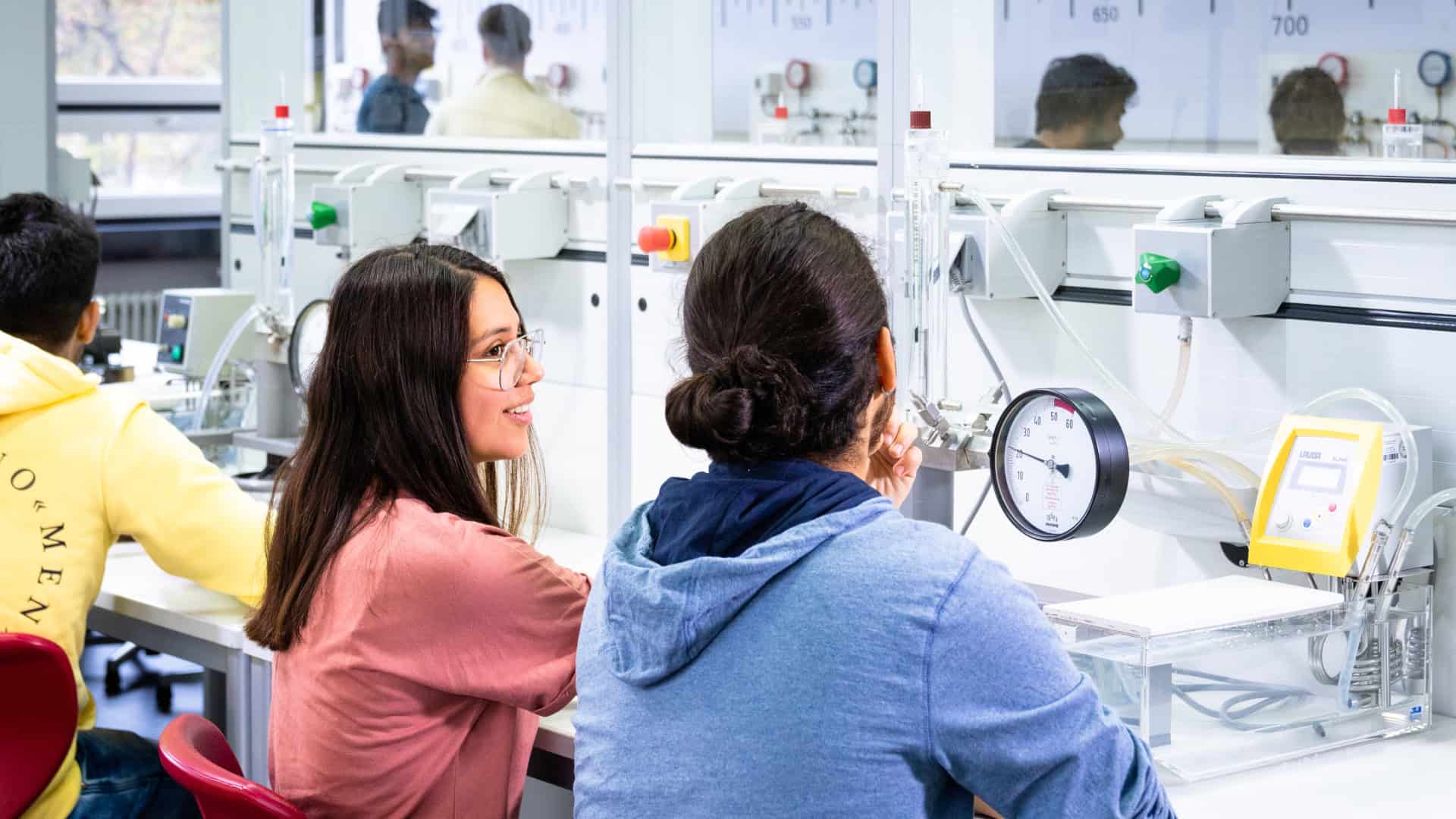 Innovative university students conducting scientific experiments in a modern laboratory.